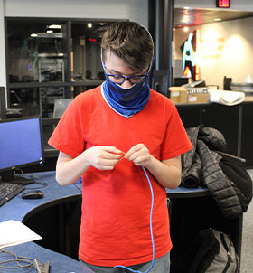 Student working on computer wires