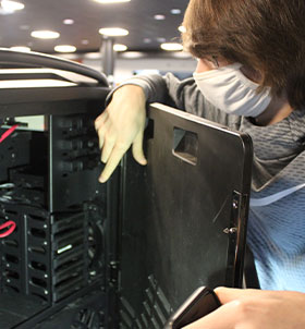 Student working on open computer tower